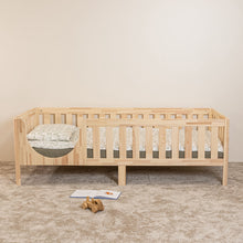 Front view of EZRA Montessori toddler bed on legs with rounded entrance and natural pine safety rails