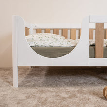 Rounded entrance detail of EZRA Montessori toddler bed on legs with oak veneer rails