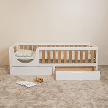 EZRA Montessori toddler bed with oak veneer rails showing one underbed storage drawer open