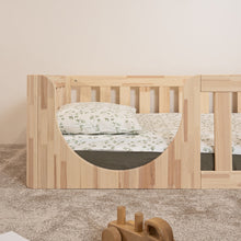 Front detail of the low rounded entry on the EZRA Montessori toddler floor bed in natural pine