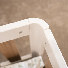 Close-up of the smooth rounded white corner on the EZRA Montessori toddler floor bed with oak veneer rails