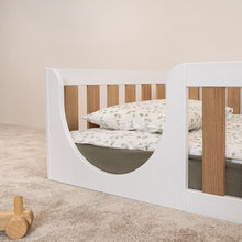 Close-up of the rounded entrance on the EZRA Montessori toddler floor bed with white pine frame and oak veneer rails