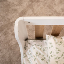 Top view of the rounded white frame corner and oak veneer rail on the EZRA Montessori toddler floor bed