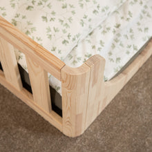Close-up of the smooth rounded corner detail on the EZRA Montessori toddler floor bed in natural pine