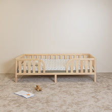 Front view of Montessori toddler bed on legs with rounded middle opening and safety rails
