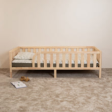 Front view of Montessori toddler bed on legs with rounded opening and safety rails