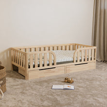 Angled view of Montessori toddler bed with rounded middle opening and closed storage drawers