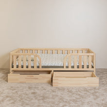 Front view of Montessori toddler bed with rounded middle opening and two open under-bed storage drawers