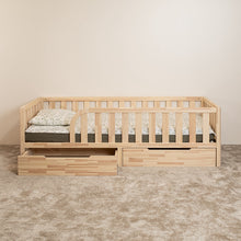 Front view of Montessori toddler bed with rounded opening and under-bed storage drawers