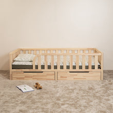 Front view of Montessori toddler bed with rounded opening and two closed storage drawers