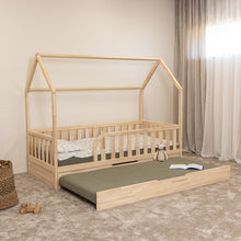 Angled view of Montessori toddler house bed with open trundle bed and rounded entrance