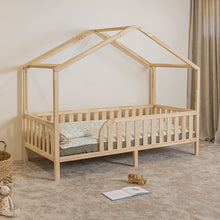 Angled view of NOLRI Montessori toddler house bed on legs with rounded opening and natural pine safety rails