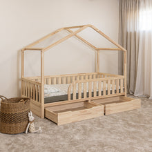 Angled view of NOLRI Montessori toddler house bed with rounded opening and two open storage drawers
