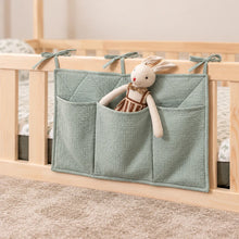 Sea Green quilted bedside organiser with three fabric storage pockets and a soft bunny, attached to a Montessori bed.