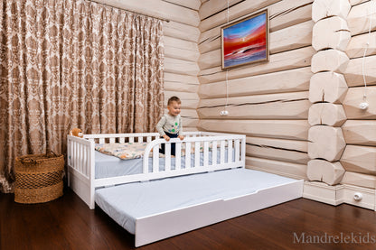 White Montessori toddler bed with rails and pull-out extra bed