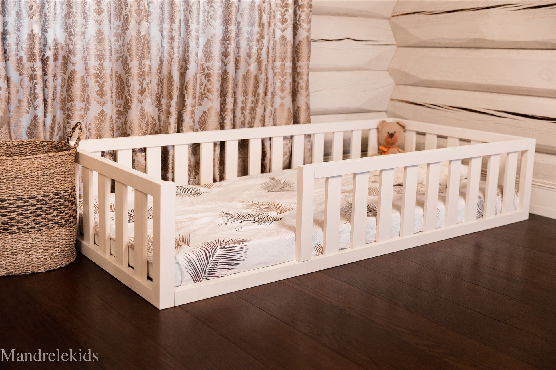 White Montessori toddler floor bed with rails