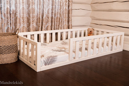 White Montessori toddler floor bed with rails
