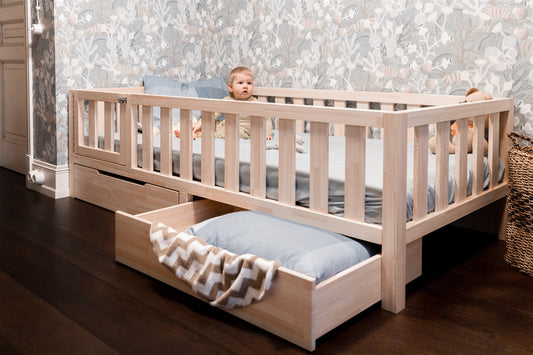 Wooden Montessori toddler bed with rails and built-in storage drawer